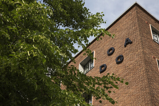 DOGA-bygget sett utenfra, sommer, nærbilde av DOGA-logoen.